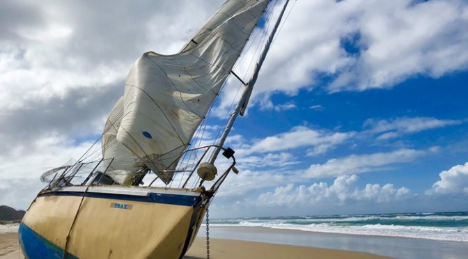 white-sail-boat-on-beach